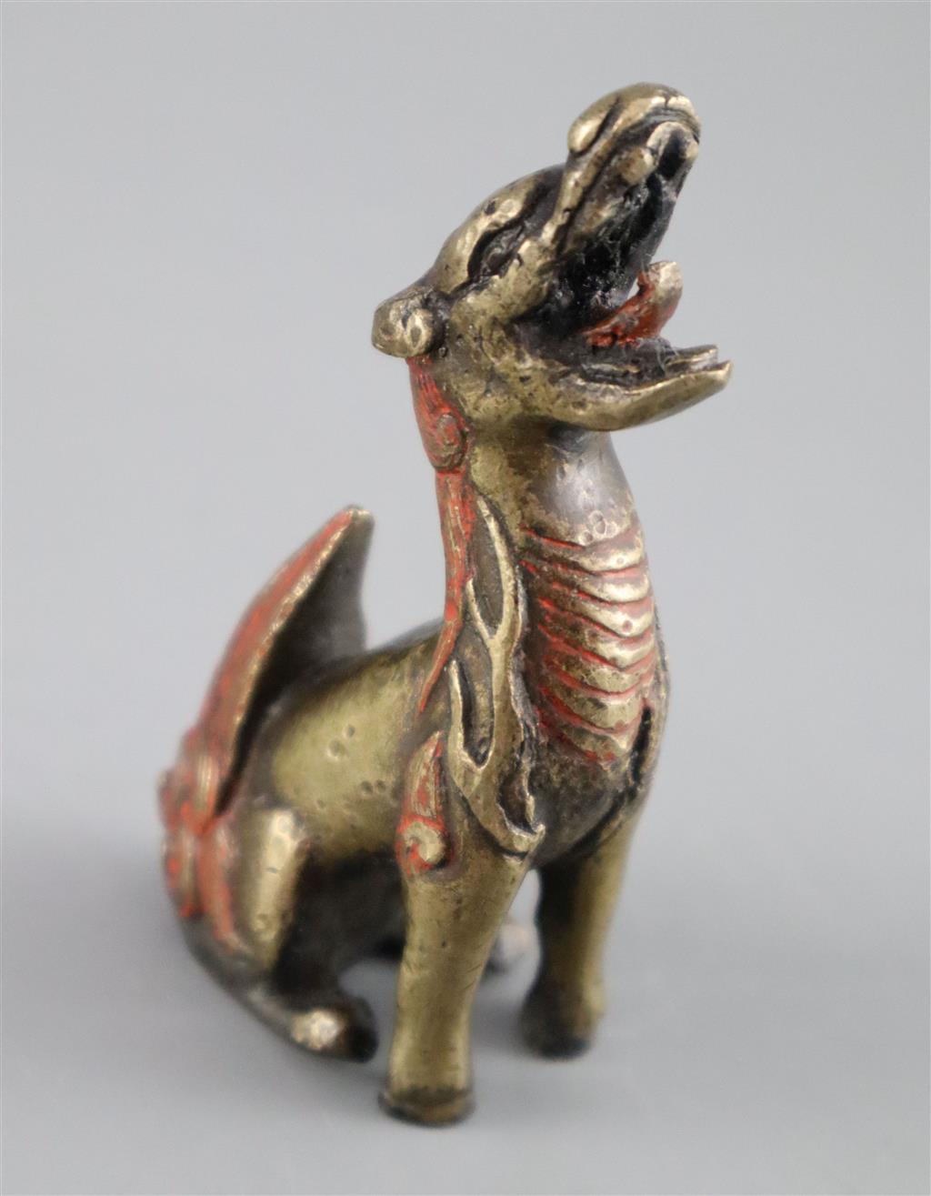 A Chinese bronze qilin scroll weight, 17th century, 8cm high